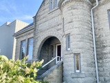 close up of front of old part of listowel library, spring flowers in corner of image