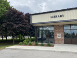 photograph of front of building labelled library, big windows and a library mail slot